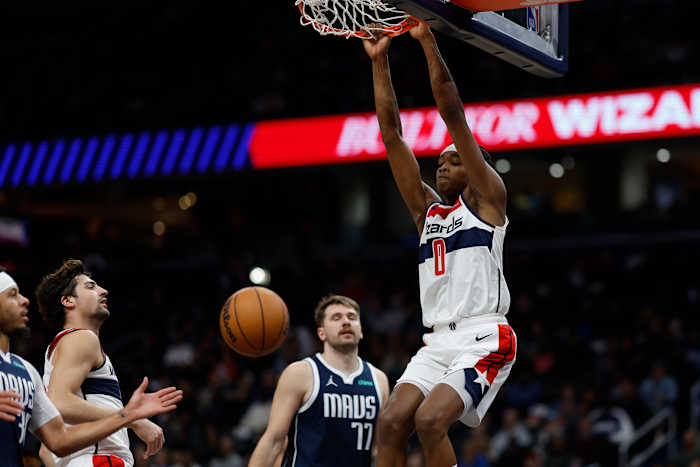 Washington Wizards guard Bilal Coulibaly (0) dunks the ball as Dallas Mavericks guard Luka Doncic (77) looks on in the fourth quarter at Capital One Arena